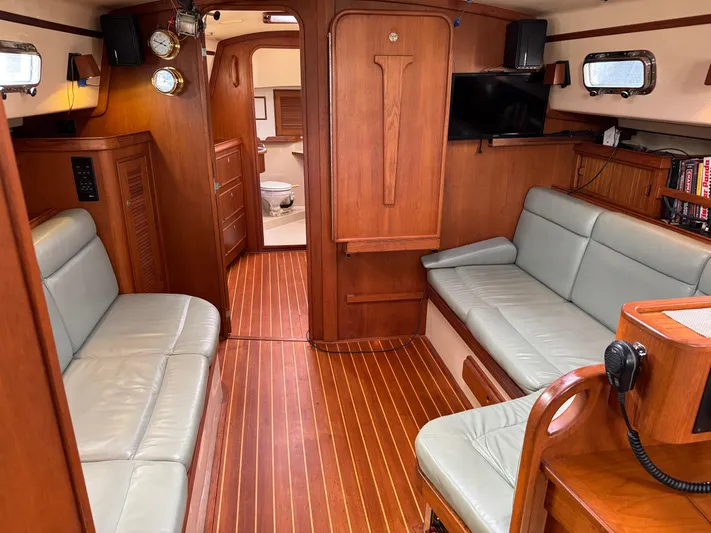 Otter II Yacht Photos Pics Interior of 1999 Island Packet 45 sailboat with wood finish and seating area.