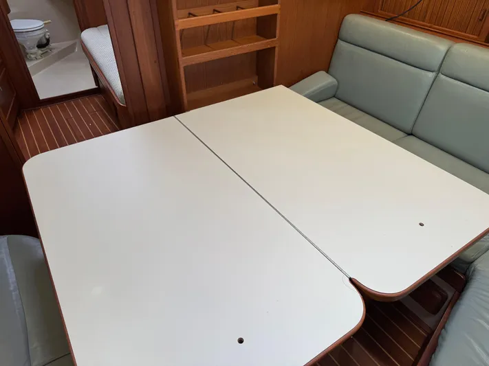 Otter II Yacht Photos Pics Interior of 1999 Island Packet 45 yacht with dining table and cushioned seating.