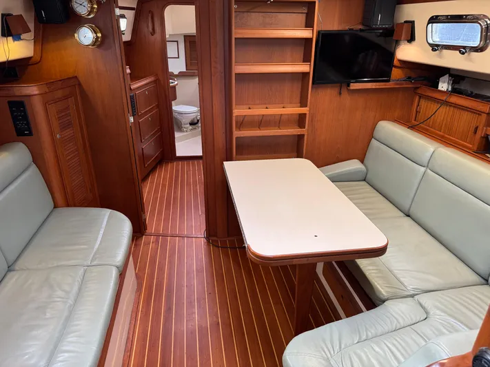 Otter II Yacht Photos Pics Interior of 1999 Island Packet 45 yacht with wooden flooring and comfortable seating.