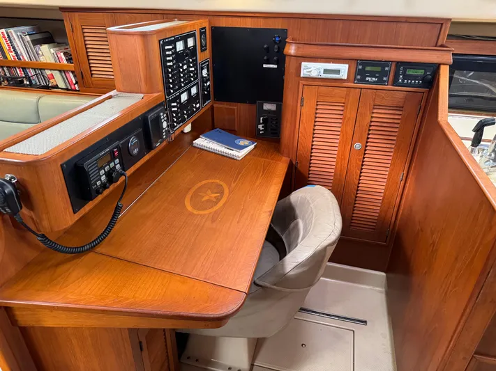 Otter II Yacht Photos Pics Navigation station of 1999 Island Packet 45 yacht with control panels and wooden desk.