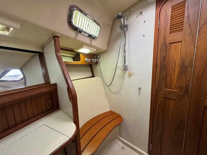 Otter II Yacht Photos Pics 1999 Island Packet 45 yacht bathroom with wooden accents and shower.