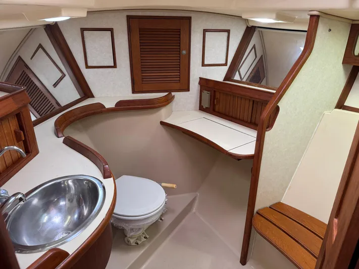 Otter II Yacht Photos Pics 1999 Island Packet 45 yacht bathroom with wooden accents and stainless steel sink.