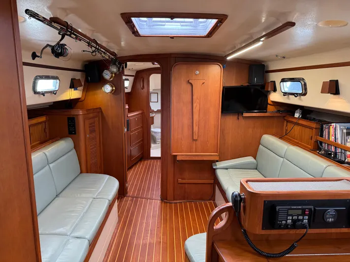 Otter II Yacht Photos Pics Interior of 1999 Island Packet 45 sailboat with wood finish and seating area.