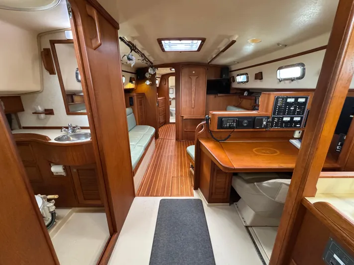 Otter II Yacht Photos Pics Interior of 1999 Island Packet 45 sailboat with wood finish and navigation station.