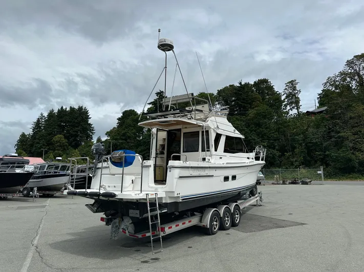  Yacht Photos Pics 2016 Cutwater CB boat on trailer, parked outdoors with trees in the background.