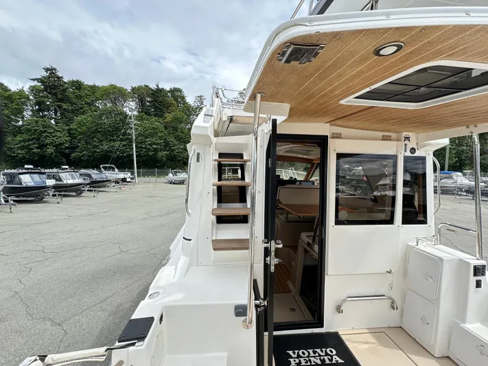  Yacht Photos Pics 2016 Cutwater CB boat with open cabin door, docked in a marina.