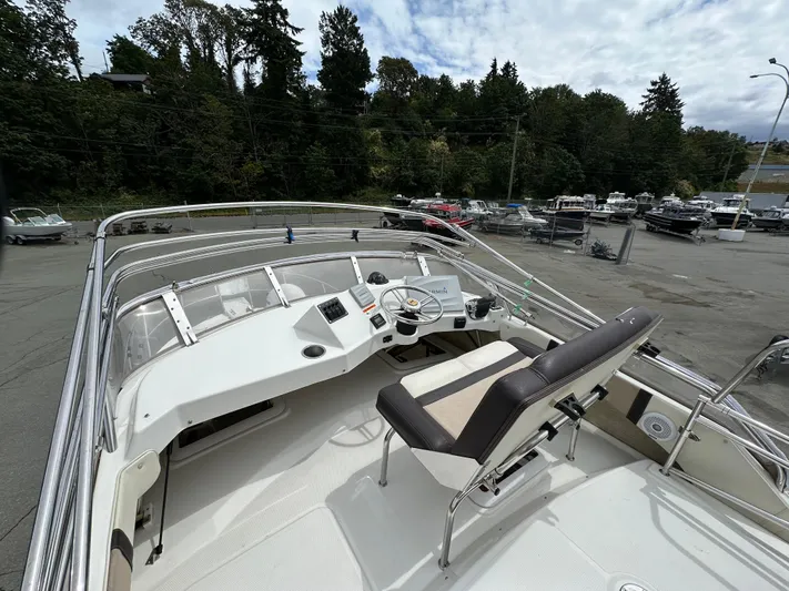  Yacht Photos Pics 2016 Cutwater CB boat helm with steering wheel and controls, parked in a marina.
