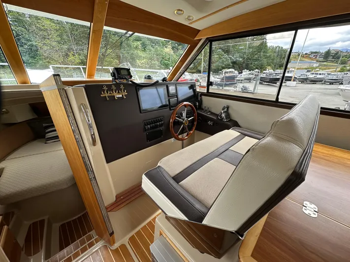  Yacht Photos Pics 2016 Cutwater CB boat interior with steering wheel, dashboard, and seating.