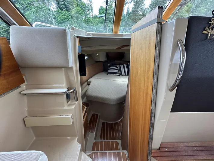  Yacht Photos Pics Interior of a 2016 Cutwater CB boat with cozy cabin and wooden accents.