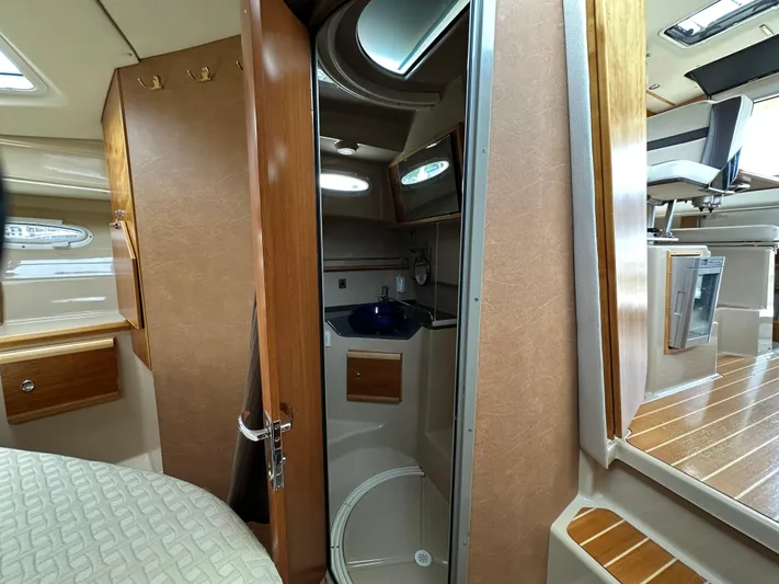  Yacht Photos Pics Interior of a 2016 Cutwater CB boat featuring a compact bathroom and wooden cabinetry.