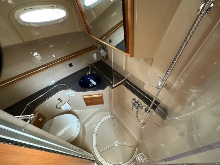  Yacht Photos Pics 2016 Cutwater CB boat bathroom with shower, sink, and toilet in compact layout.