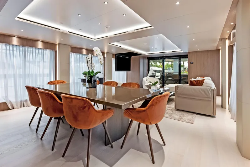 Ciao M Yacht Photos Pics Luxurious yacht interior with elegant dining area, modern decor, and plush seating, 2023 Custom Line 106'.