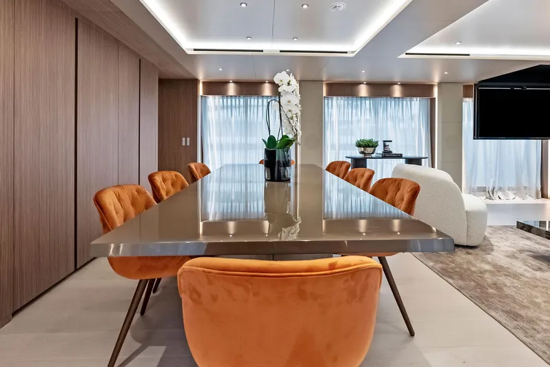 Ciao M Yacht Photos Pics Luxurious dining area on 2023 Custom Line 106' yacht with elegant decor and orange chairs.
