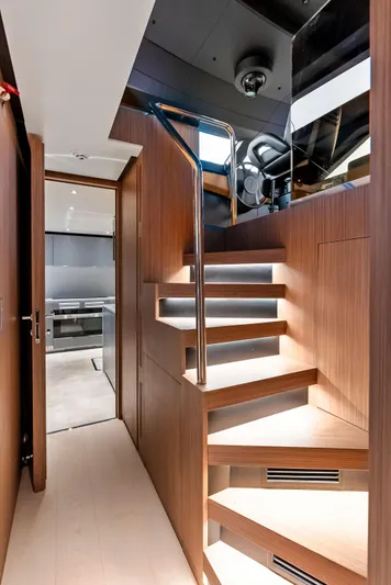 Ciao M Yacht Photos Pics Luxurious interior of 2023 Custom Line 106' yacht with modern wooden staircase.