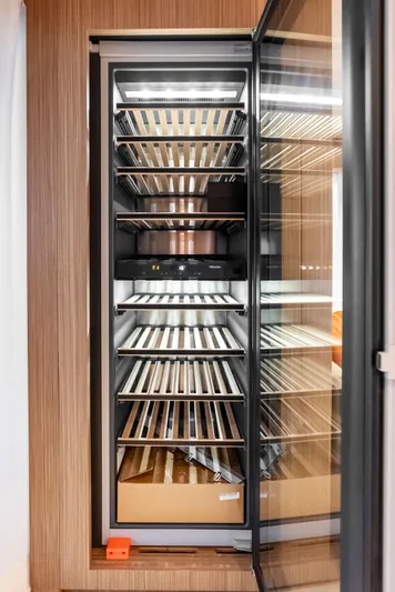 Ciao M Yacht Photos Pics Modern wine cooler with wooden shelves on a Custom Line 106' yacht, 2023 model.