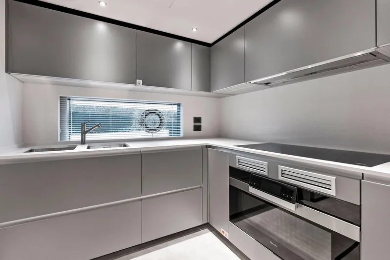 Ciao M Yacht Photos Pics Modern kitchen in 2023 Custom Line 106' yacht with sleek gray cabinetry and appliances.