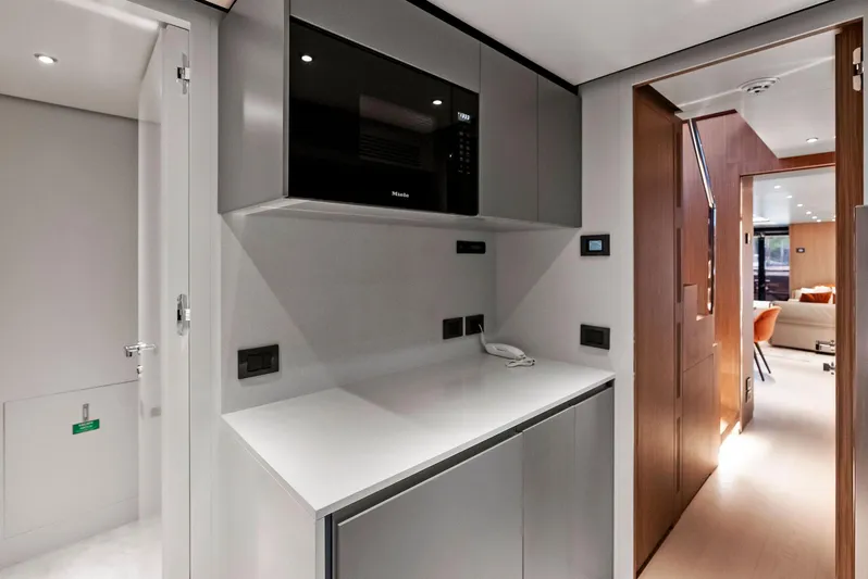 Ciao M Yacht Photos Pics Modern kitchen area on 2023 Custom Line 106' yacht with sleek cabinetry and appliances.