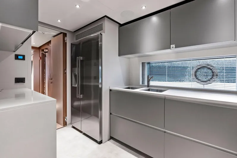 Ciao M Yacht Photos Pics Modern kitchen interior on 2023 Custom Line 106' yacht, featuring sleek cabinetry and stainless steel appliances.