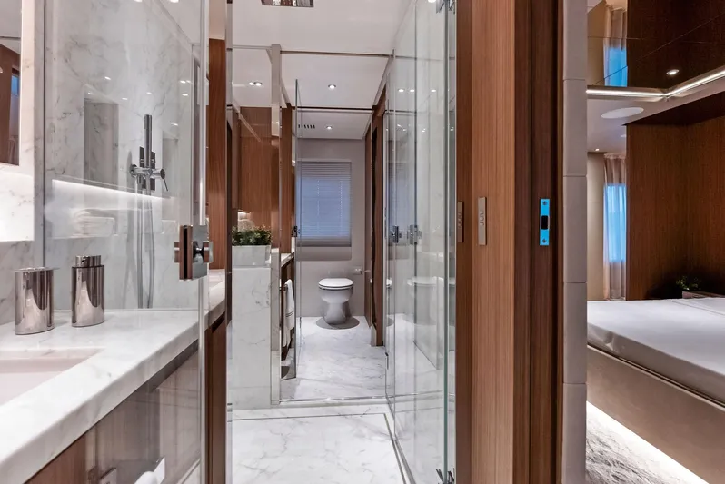 Ciao M Yacht Photos Pics Luxurious yacht bathroom with marble accents, modern fixtures, and wooden cabinetry, 2023 Custom Line 106'.