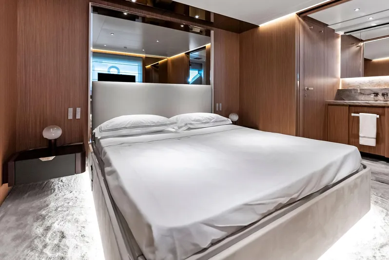 Ciao M Yacht Photos Pics Luxurious bedroom interior on 2023 Custom Line 106' yacht, featuring modern design and elegant wood finishes.