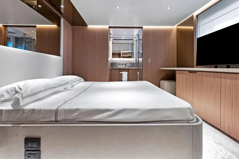 Ciao M Yacht Photos Pics Luxurious bedroom interior on 2023 Custom Line 106' yacht, featuring modern design and elegant wood finishes.