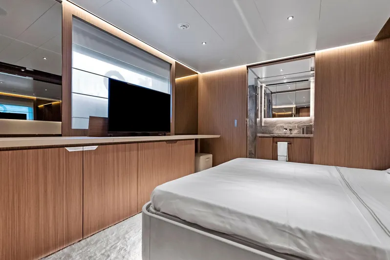 Ciao M Yacht Photos Pics Luxurious 2023 Custom Line 106' yacht bedroom with modern wood paneling and sleek design.
