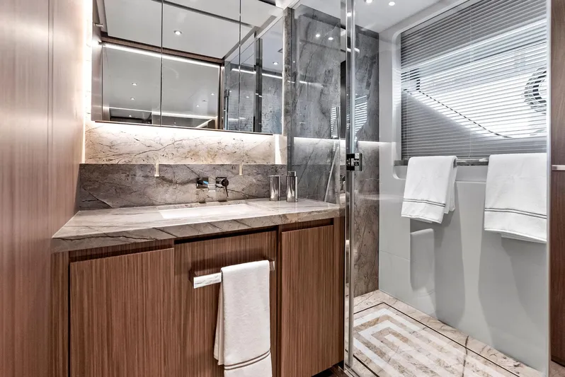 Ciao M Yacht Photos Pics Luxurious yacht bathroom with wood cabinetry, marble accents, and modern fixtures, 2023 Custom Line 106'.