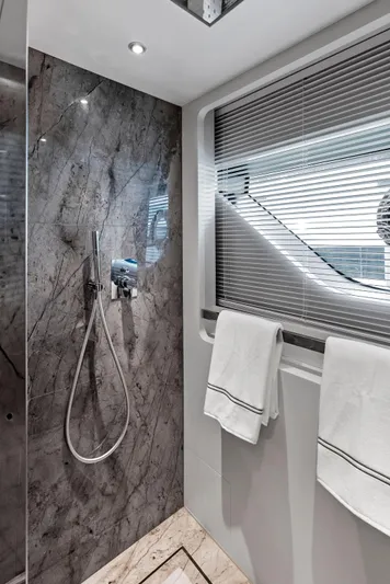 Ciao M Yacht Photos Pics Luxurious yacht bathroom with marble shower, modern fixtures, and elegant towels, 2023 Custom Line 106'.