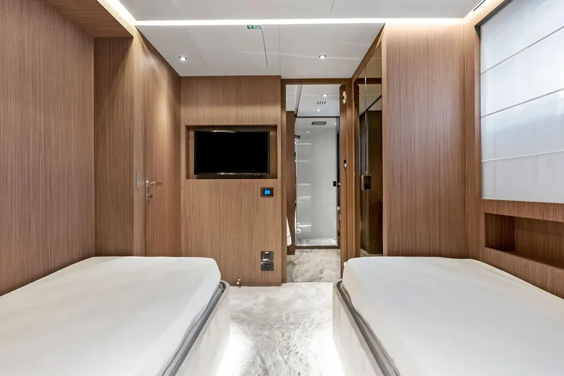 Ciao M Yacht Photos Pics Luxurious 2023 Custom Line 106' yacht cabin with twin beds and modern wood paneling.
