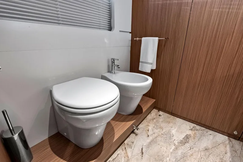 Ciao M Yacht Photos Pics Luxurious bathroom in 2023 Custom Line 106' yacht with modern fixtures and marble flooring.