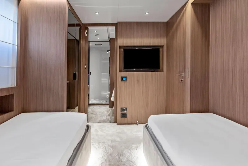 Ciao M Yacht Photos Pics Luxurious 2023 Custom Line 106' yacht bedroom with twin beds and modern wood paneling.