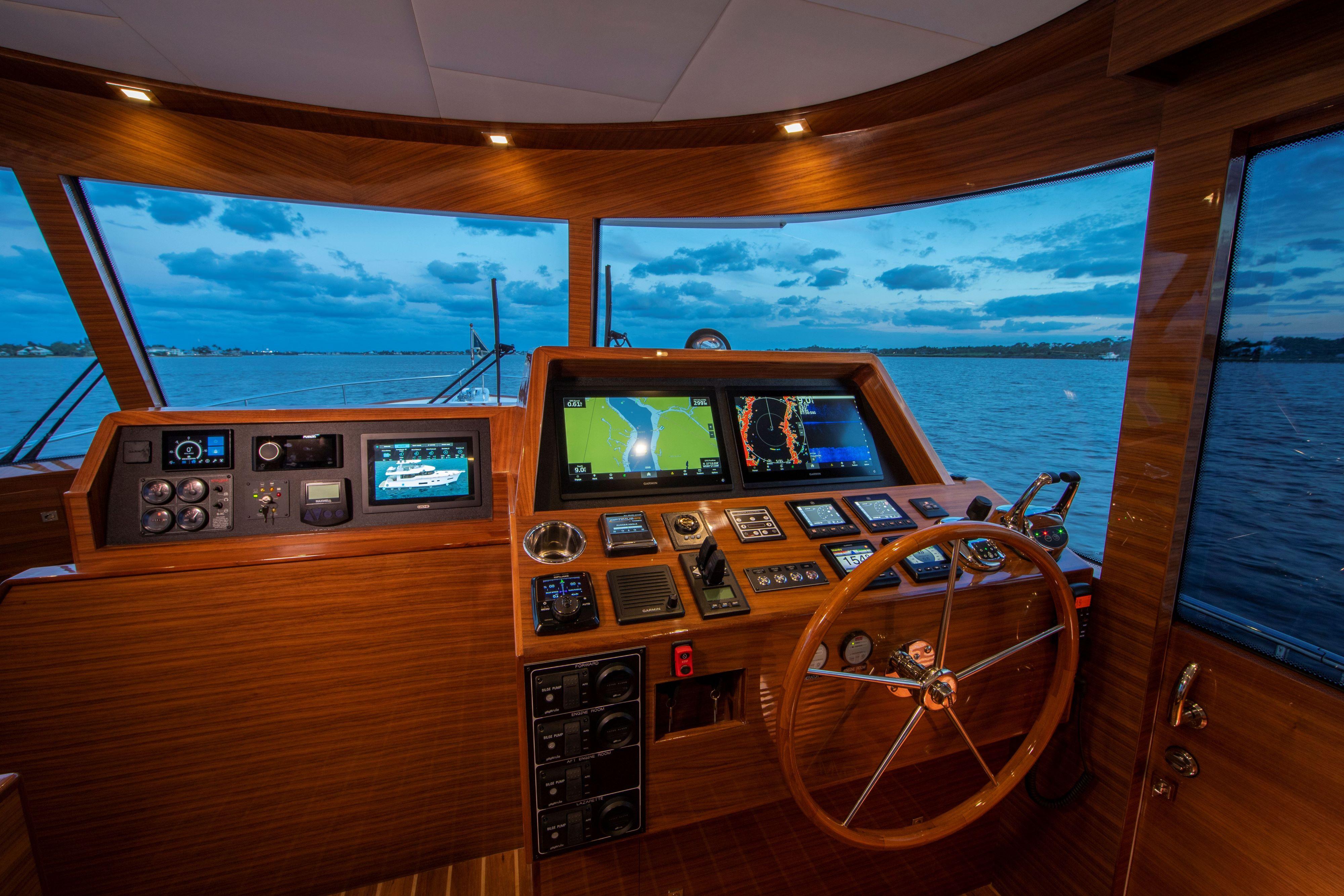 Modern helm of the 2025 Summit 54 yacht with advanced navigation systems.