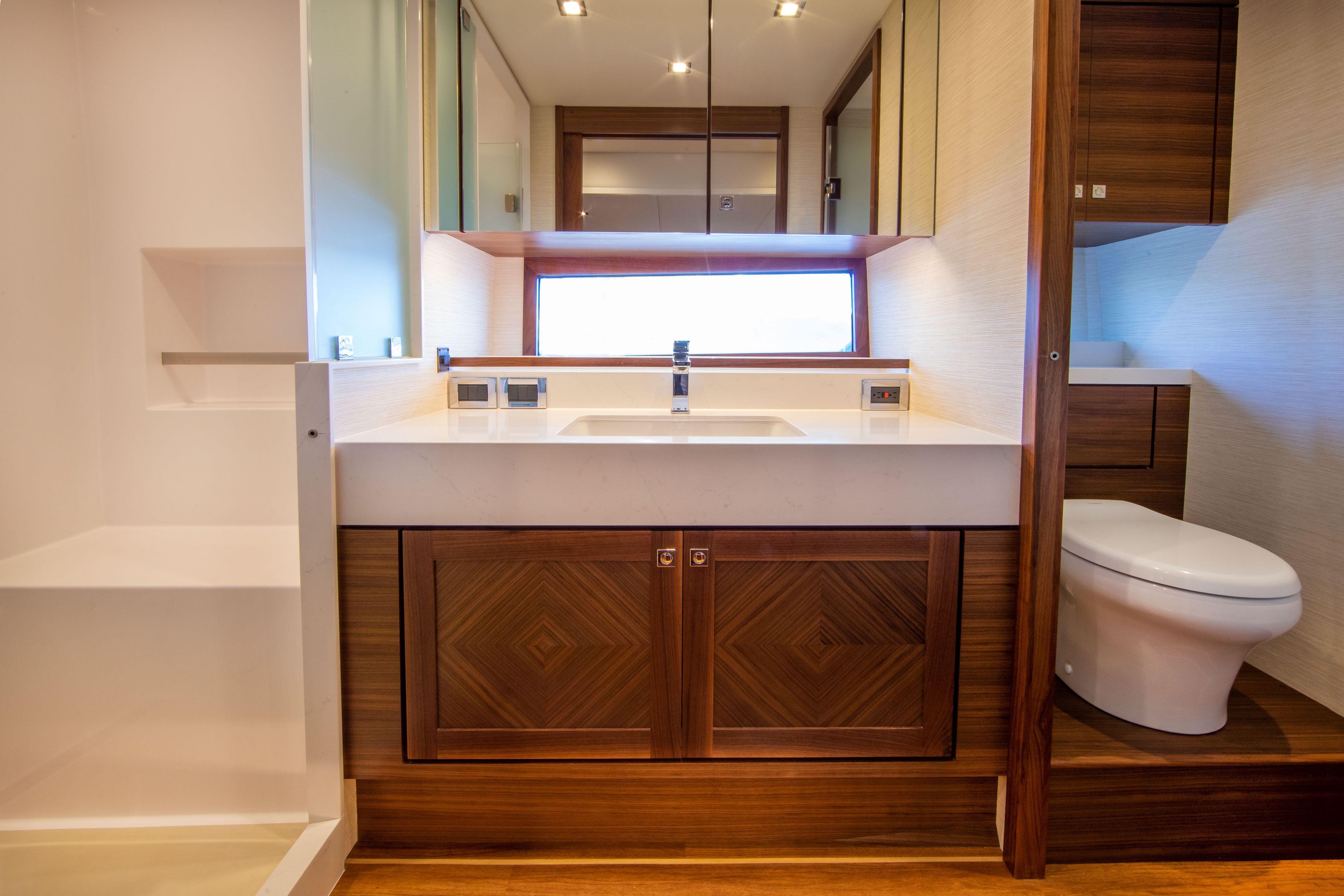 Modern bathroom in 2025 Summit 54 yacht with wooden cabinetry and sleek fixtures.