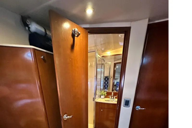 Invictus II Yacht Photos Pics Interior of 2006 Meridian 368 yacht showing wooden doors and bathroom with sink.