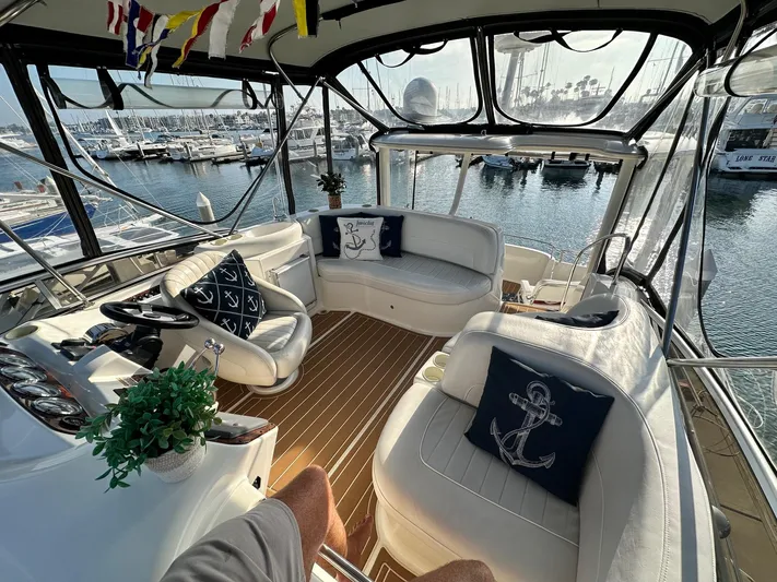 Invictus II Yacht Photos Pics Luxurious 2006 Meridian 368 yacht interior with nautical decor and marina view.