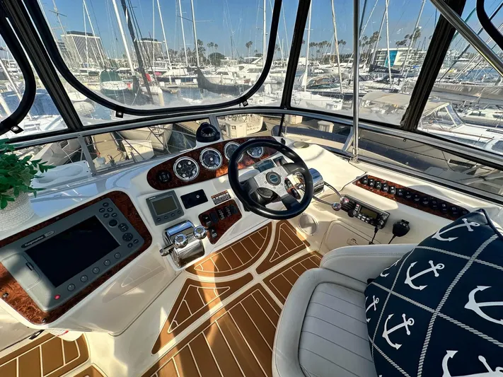 Invictus II Yacht Photos Pics Helm of 2006 Meridian 368 yacht with nautical decor and marina view.