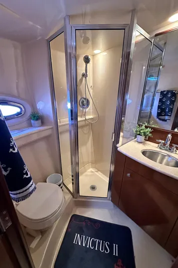 Invictus II Yacht Photos Pics Luxurious 2006 Meridian 368 yacht bathroom with shower, sink, and nautical decor.