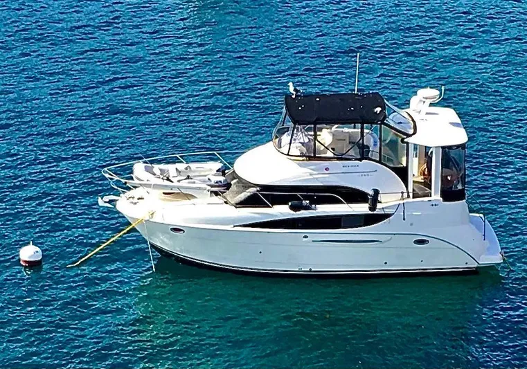 Invictus II Yacht Photos Pics 2006 Meridian 368 yacht anchored on clear blue water.