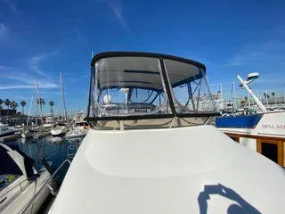 Invictus II Yacht Photos Pics 2006 Meridian 368 yacht docked in a marina under clear blue skies.