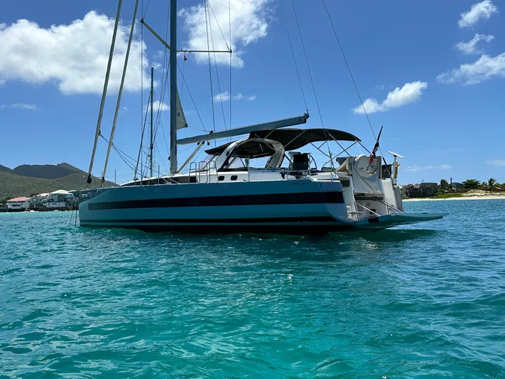  Yacht Photos Pics 2019 Beneteau Oceanis Yacht 62 sailing on clear blue water under a sunny sky.