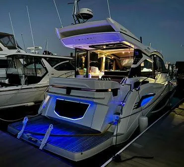  Yacht Photos Pics 2021 Galeon 425 HTS yacht docked at night with illuminated interior and exterior lights.