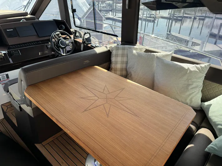  Yacht Photos Pics Interior of 2021 Galeon 425 HTS yacht with wooden table and plush seating.