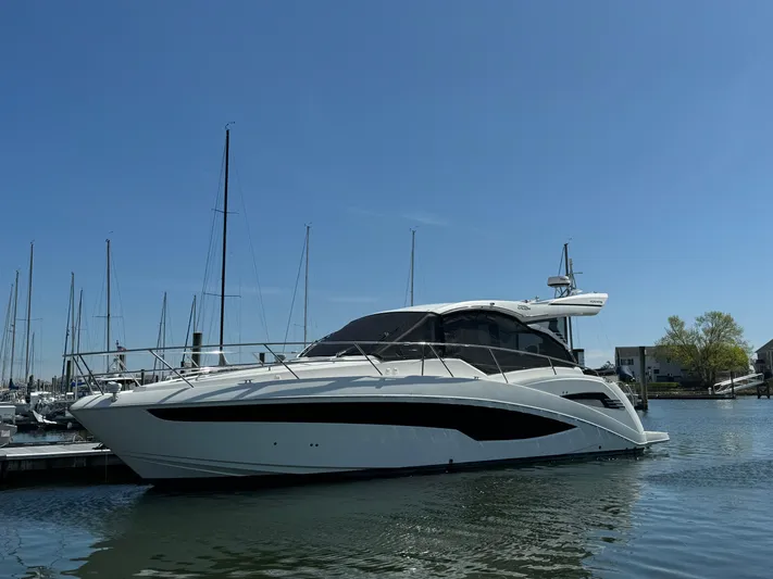  Yacht Photos Pics 2021 Galeon 425 HTS yacht docked in a marina under clear blue skies.