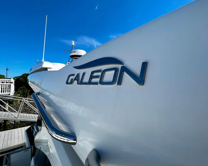 Yacht Photos Pics 2021 Galeon 425 HTS yacht with logo, docked under clear blue sky.