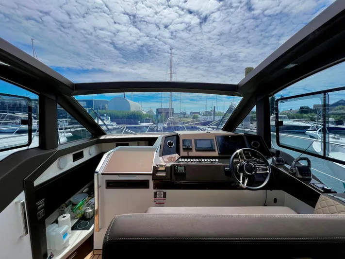  Yacht Photos Pics Interior view of 2021 Galeon 425 HTS yacht cockpit with modern controls and panoramic windows.