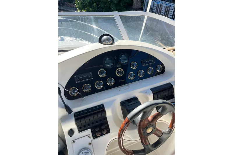 Quick X Yacht Photos Pics 2004 Cruisers Yachts 3750 Motoryacht helm with gauges and steering wheel.