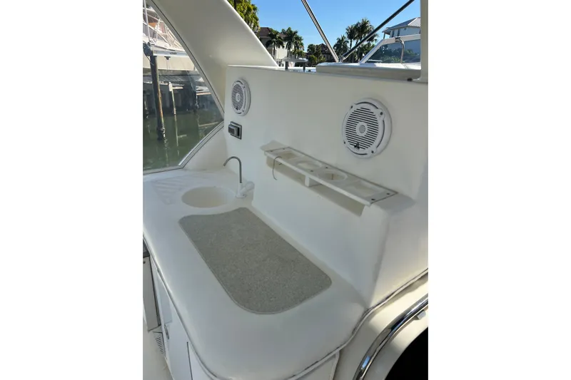 Quick X Yacht Photos Pics 2004 Cruisers Yachts 3750 Motoryacht interior with sink and speakers, docked by water.