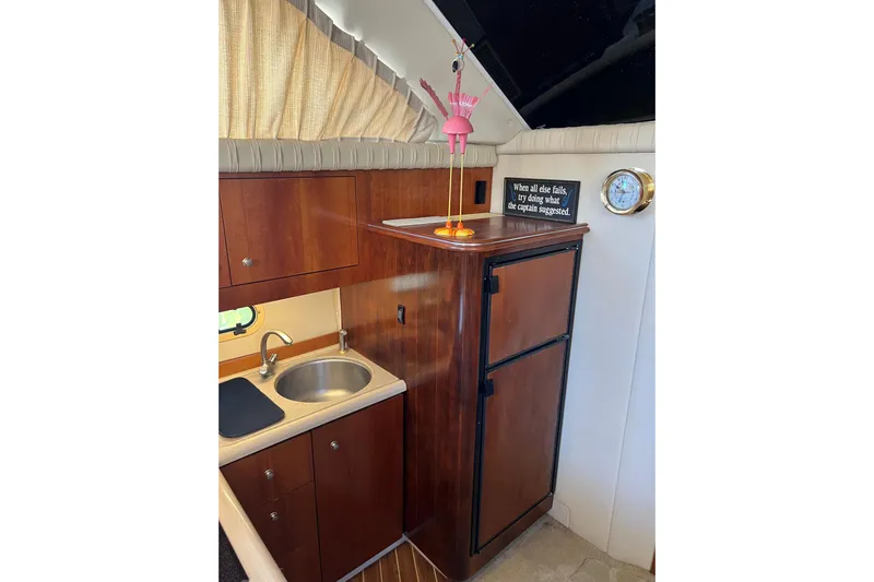 Quick X Yacht Photos Pics 2004 Cruisers Yachts 3750 Motoryacht interior with kitchenette and wooden cabinetry.