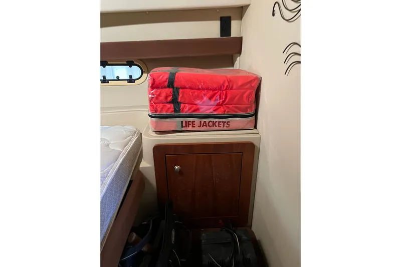 Quick X Yacht Photos Pics Red life jackets stored on a cabinet inside a 2004 Cruisers Yachts 3750 Motoryacht.