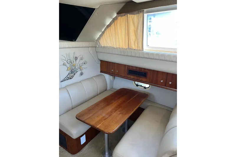 Quick X Yacht Photos Pics 2004 Cruisers Yachts 3750 Motoryacht interior with dining area, wooden table, and beige seating.